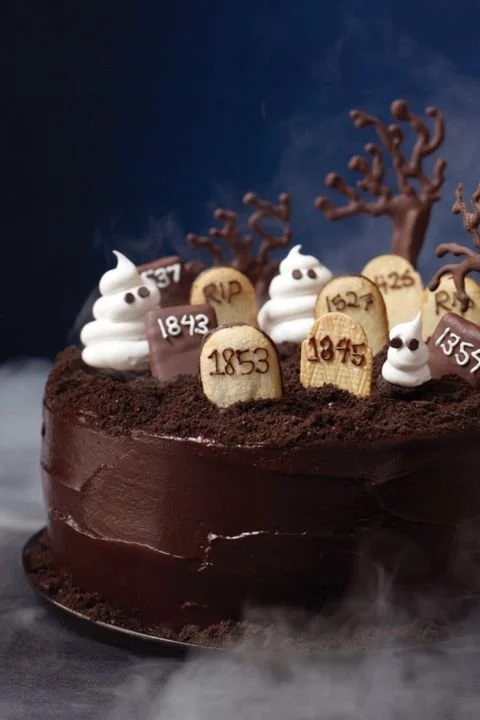 A collection of 30 scary-good Halloween cake recipes displayed on a festive table.
