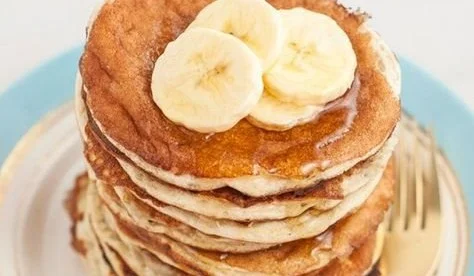 Stack of 4-ingredient protein pancakes topped with blueberries and syrup
