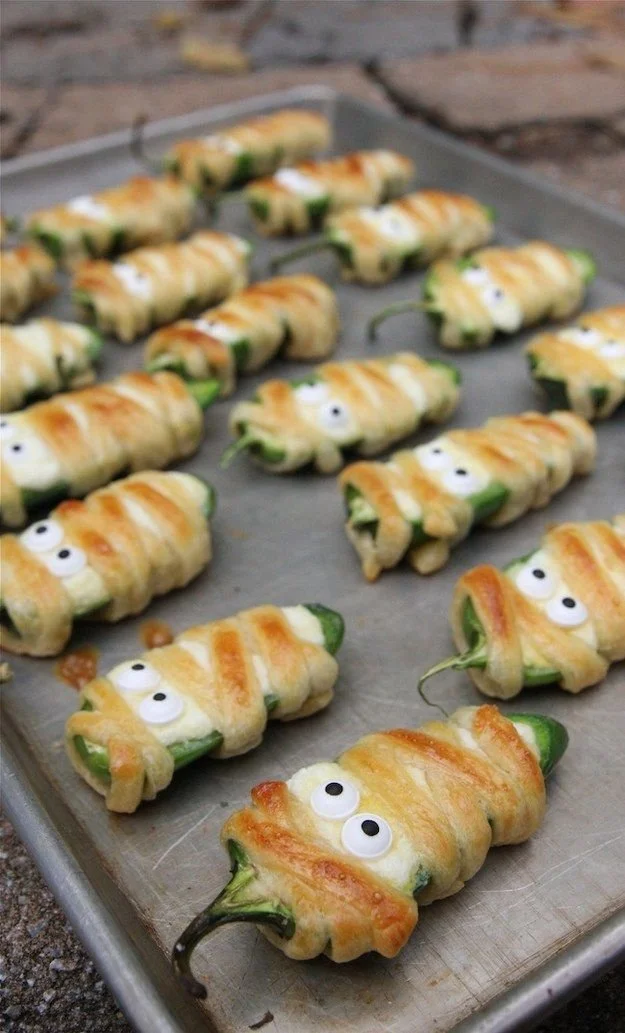 Asian inspired Halloween party food featuring mummy peppers with googly eyes.