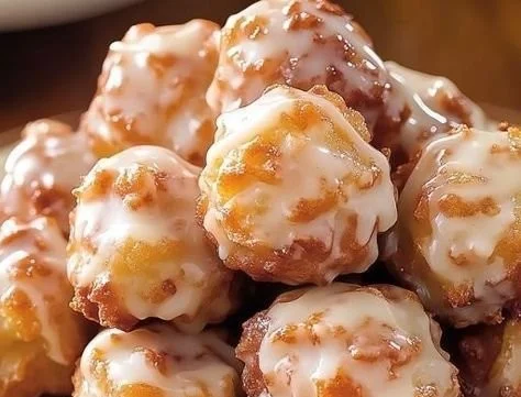 Deliciously glazed baked apple fritters on a plate, ready to enjoy.