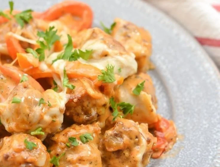 Cheesy keto sausage and peppers dish served in a skillet
