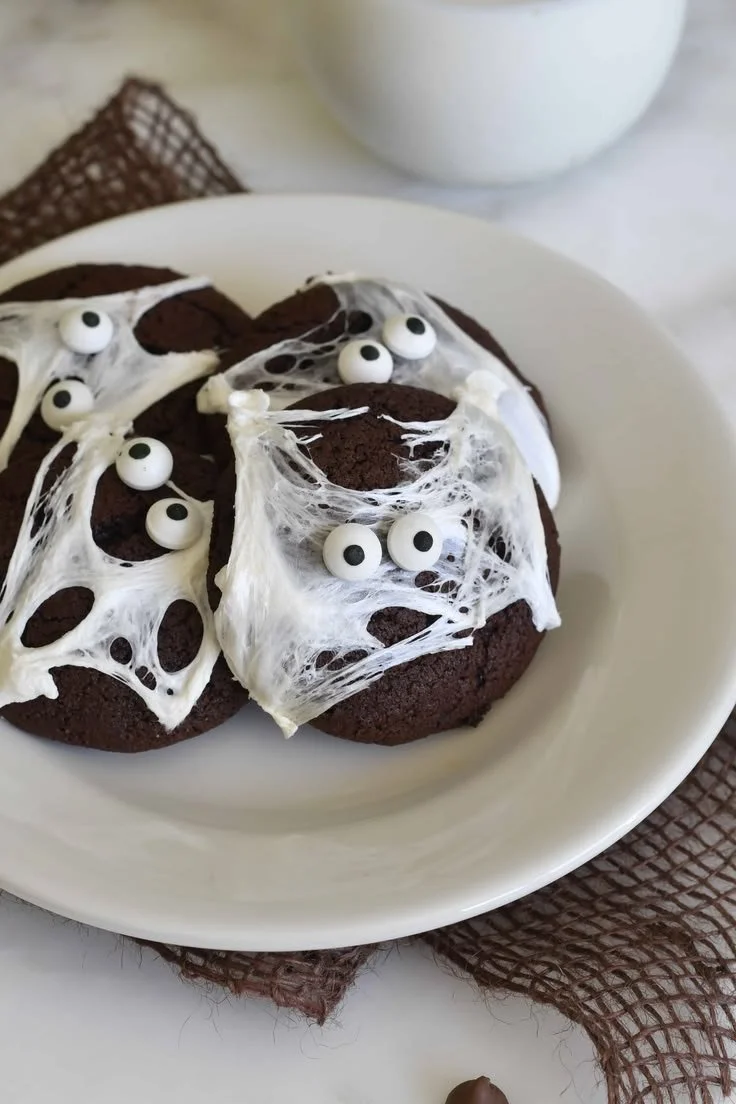 Delicious Halloween double chocolate spider web cookies on a festive plate.