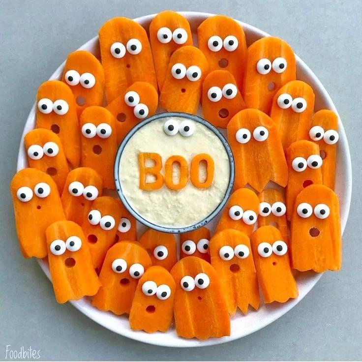 Halloween veggie tray with spooky designs and healthy snacks for kids