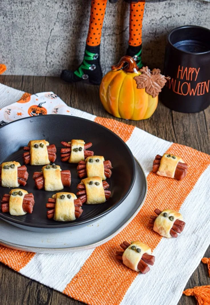 Halloween-themed hot dog spiders served on a platter.