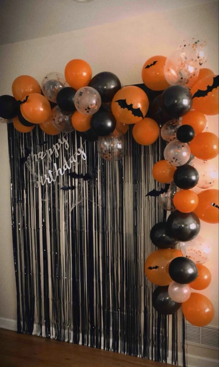 Halloween party backdrop and balloon arch decoration for a festive celebration