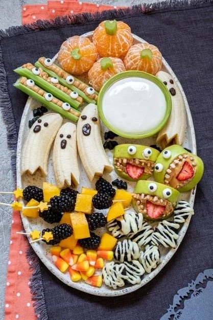 Healthy fruit Halloween treats displayed on a festive table