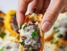 Keto Cheeseburger Stuffed Peppers served on a plate with toppings