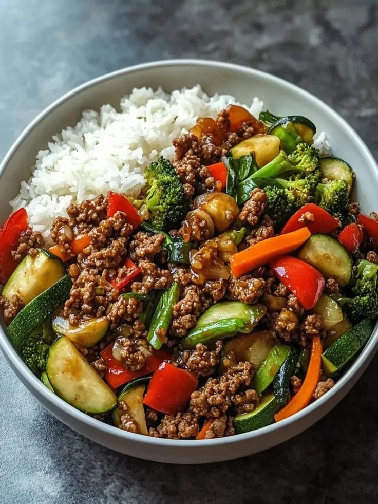 Spicy ground beef stir-fry bowl with garlic vegetables on a plate
