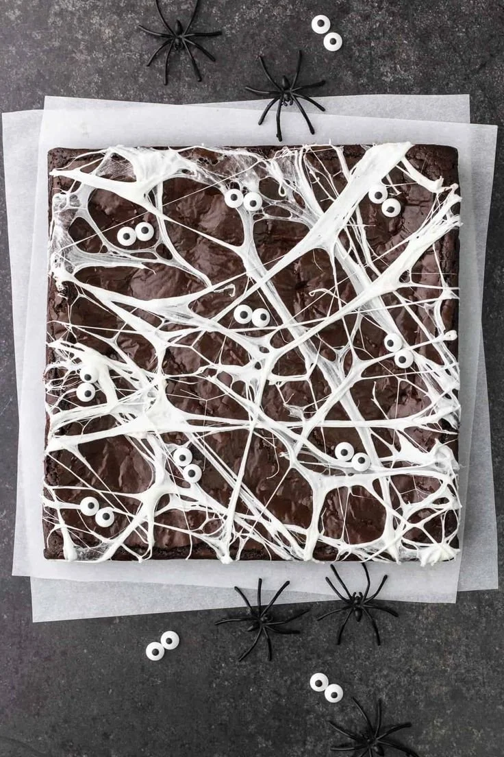 Spider Web Olive Oil Brownies topped with chocolate spider web design