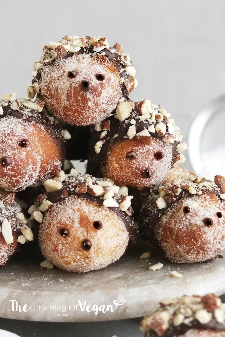 Vegan Nutella doughnut holes topped with chocolate and nuts